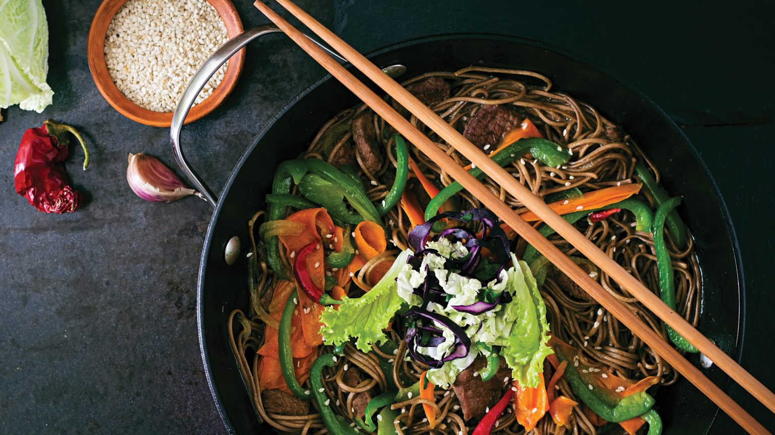 picture of stir fry noodles and chopsticks
